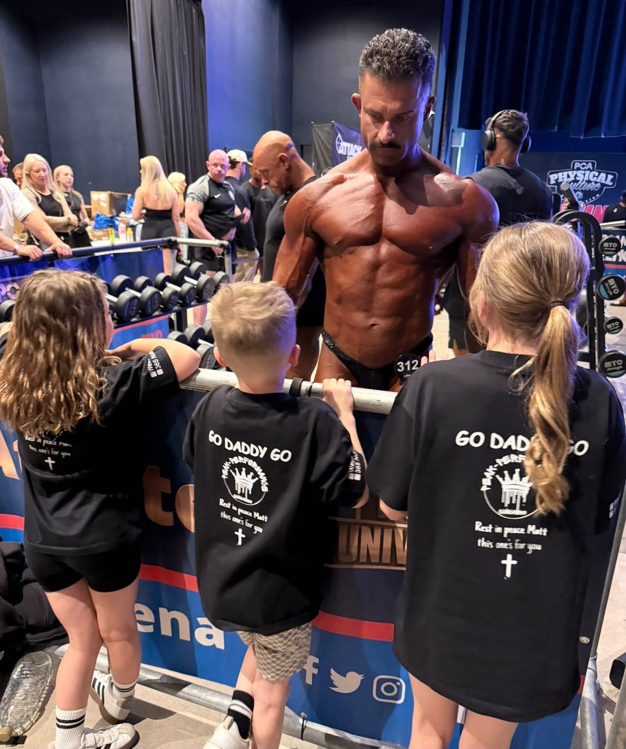 Sam backstage at a PCA show with his children in Go Daddy Go t-shirts