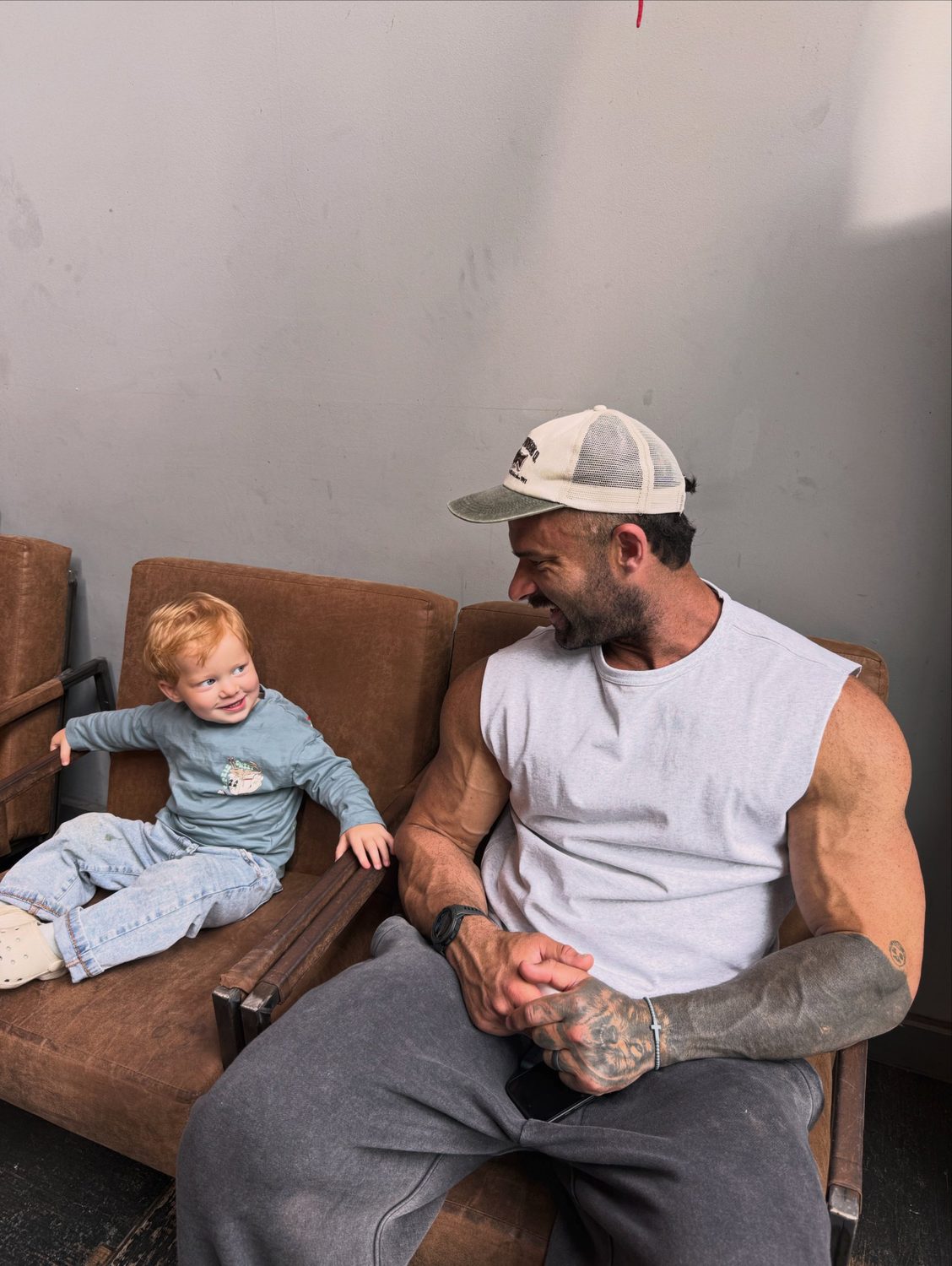 Sam laughing with his son